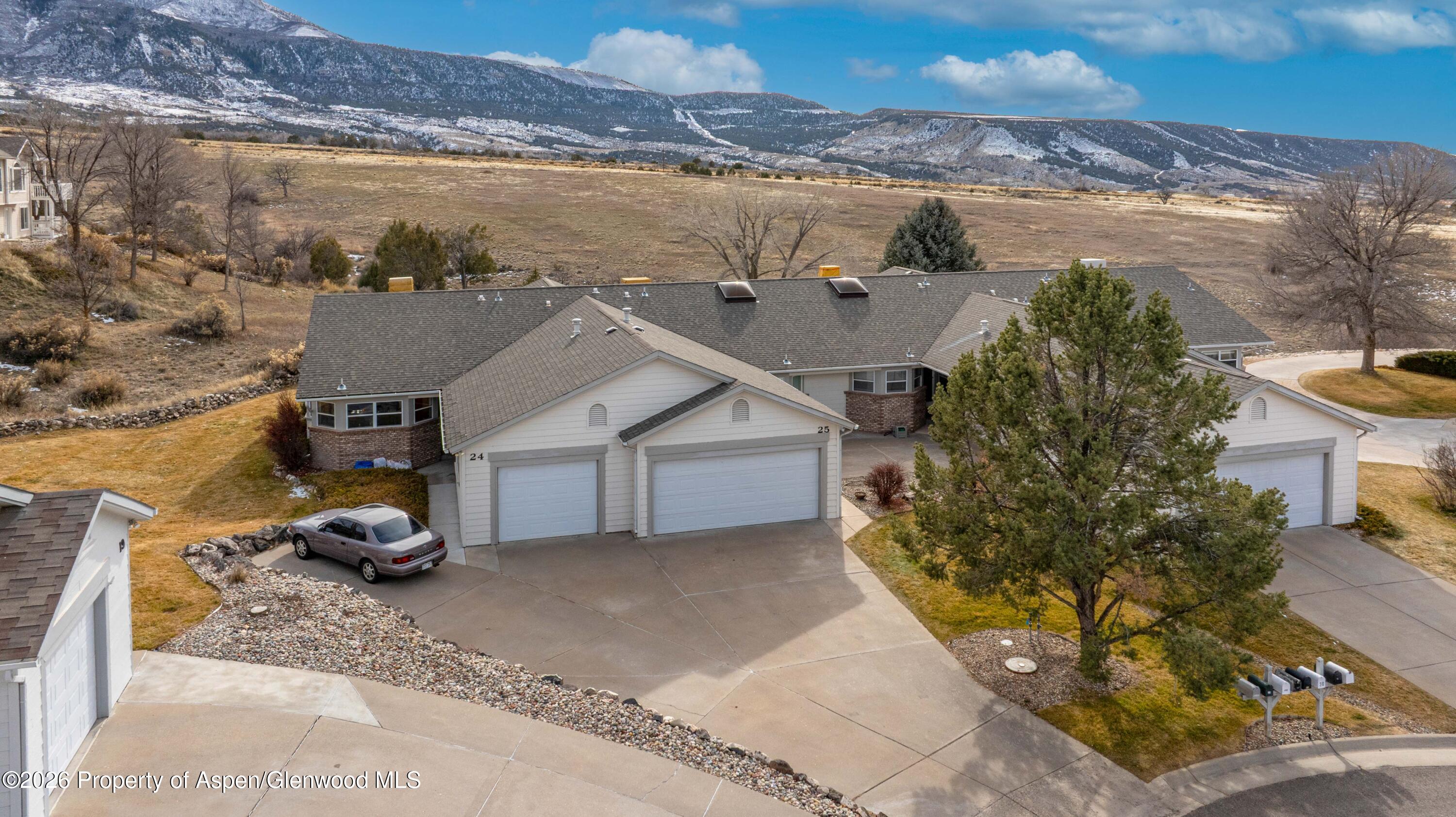 25 West Ridge Court Parachute, CO 81635 - Photo 2 of 21 a view of a house with a cars park next to a road