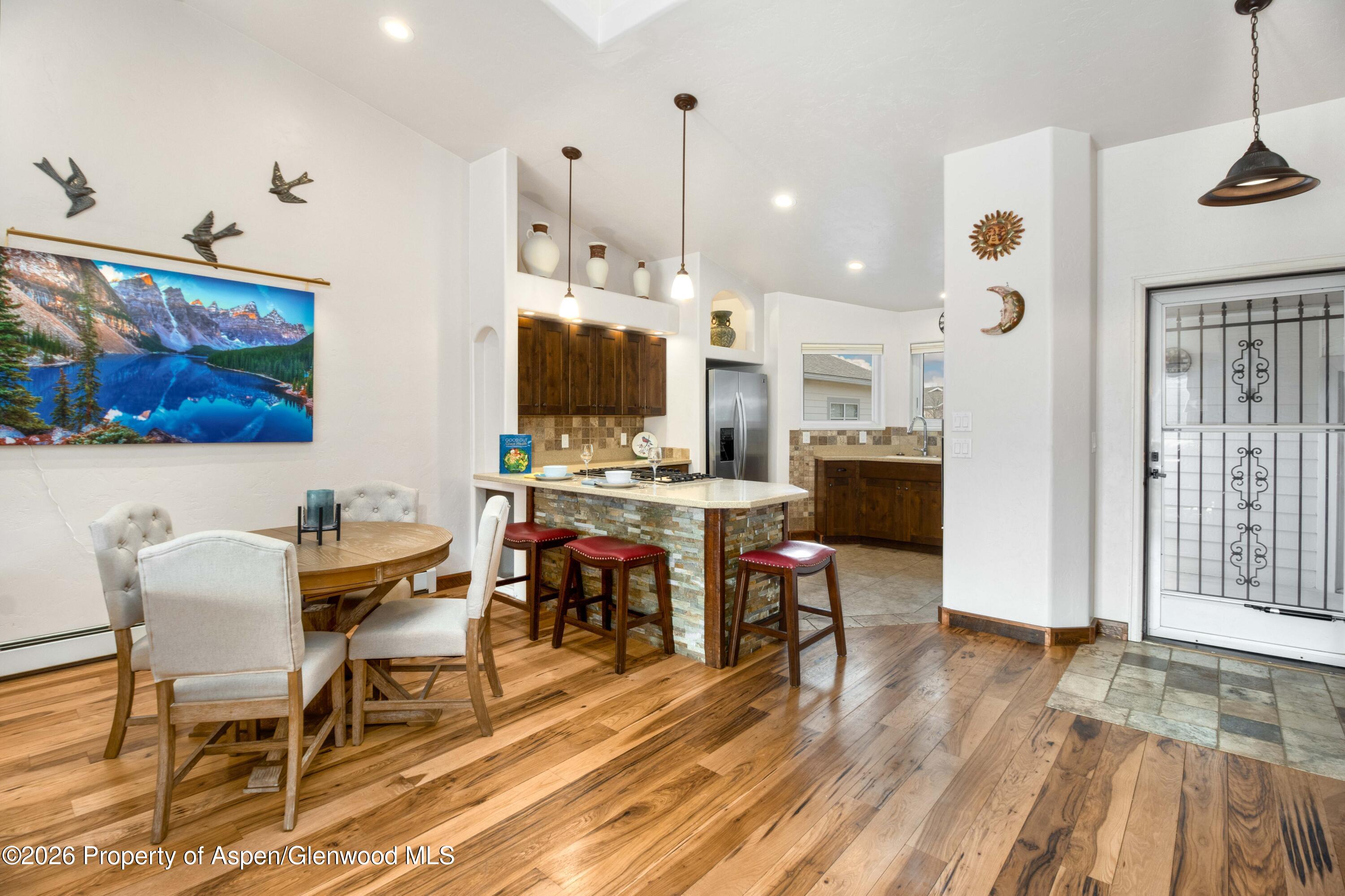 25 West Ridge Court Parachute, CO 81635 - Photo 5 of 21 a view of a dining room with furniture one side kitchen view and wooden floor