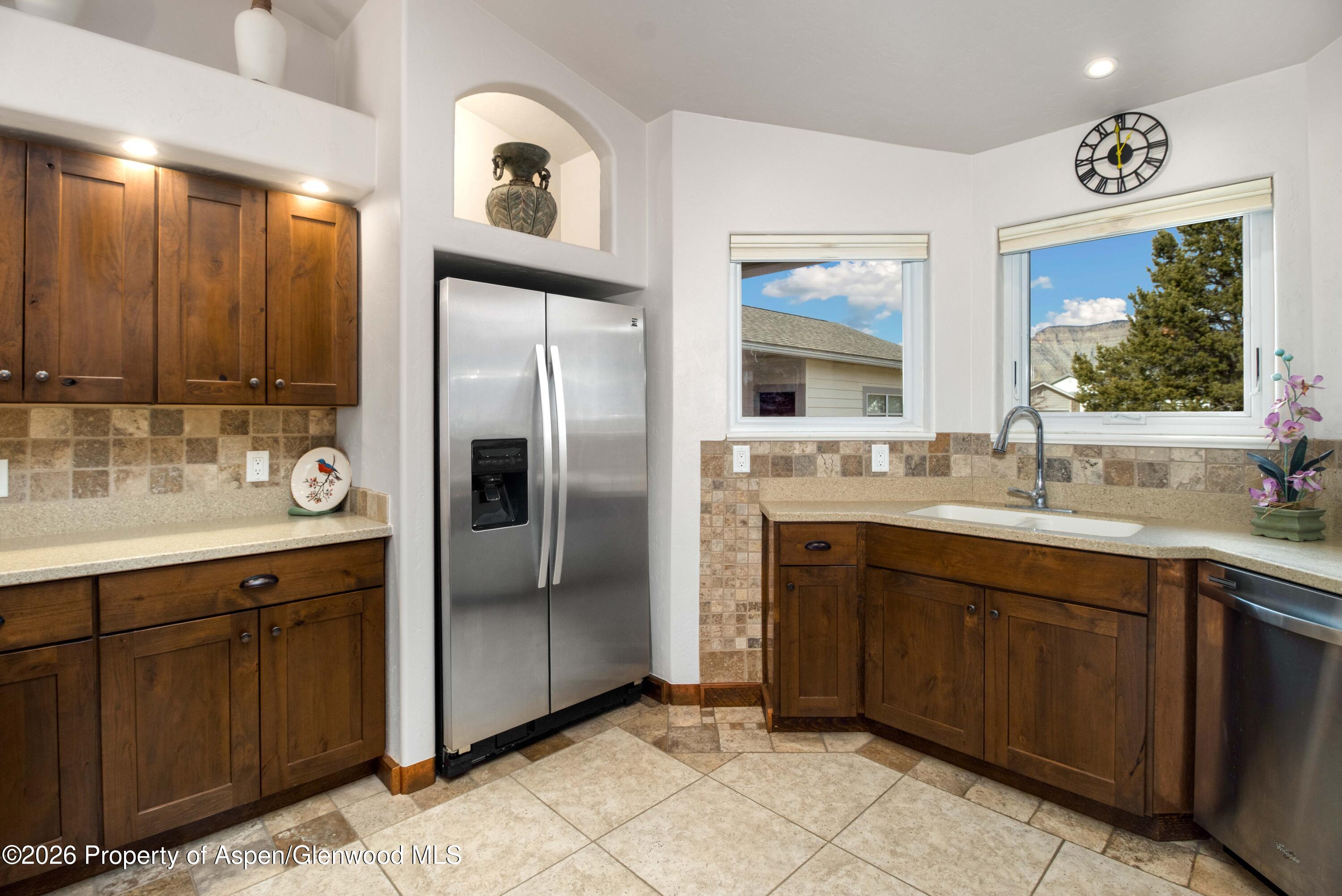 25 West Ridge Court Parachute, CO 81635 - Photo 6 of 21 a kitchen with stainless steel appliances granite countertop a refrigerator and a sink