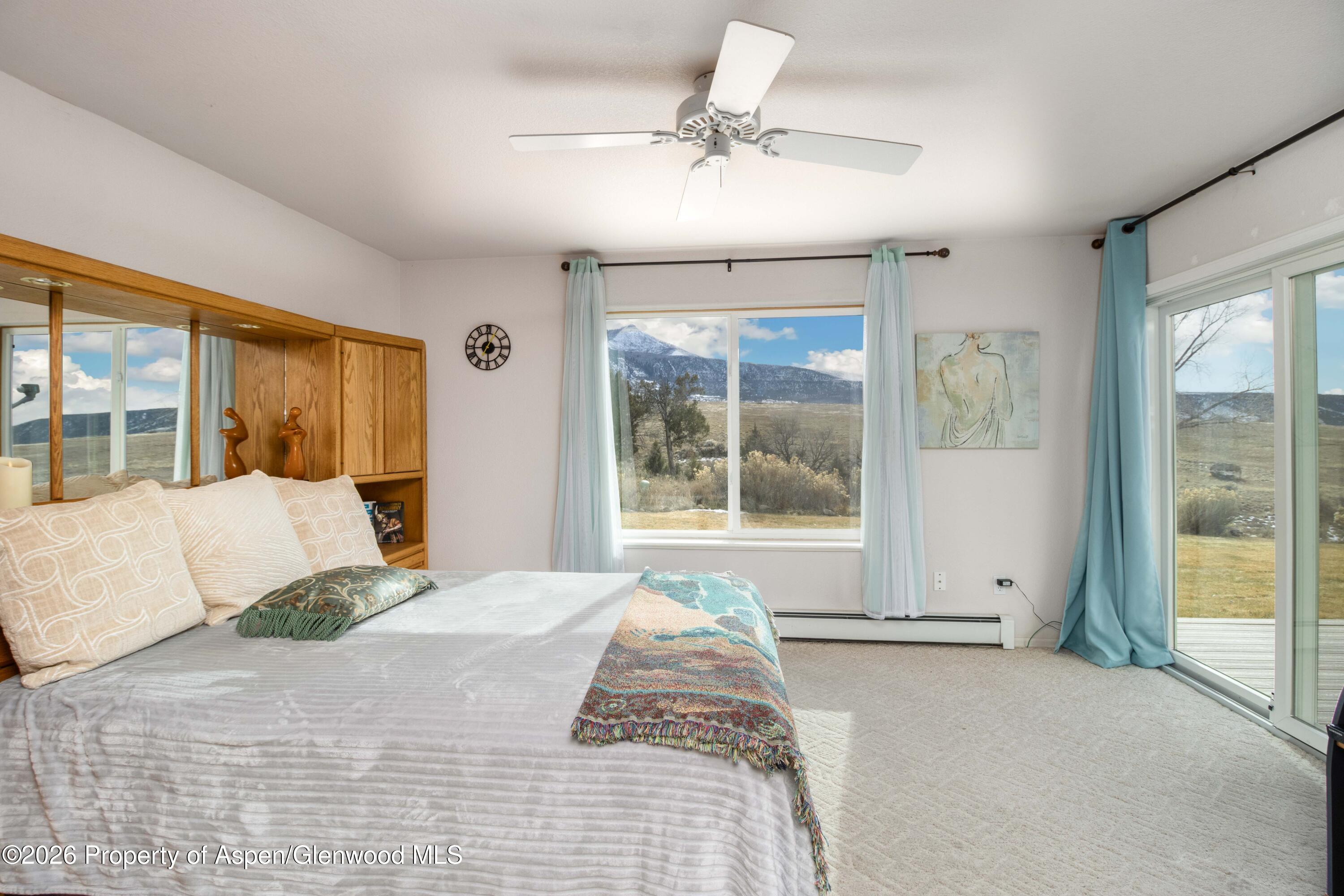 25 West Ridge Court Parachute, CO 81635 - Photo 10 of 21 a bedroom with a large bed and a large window