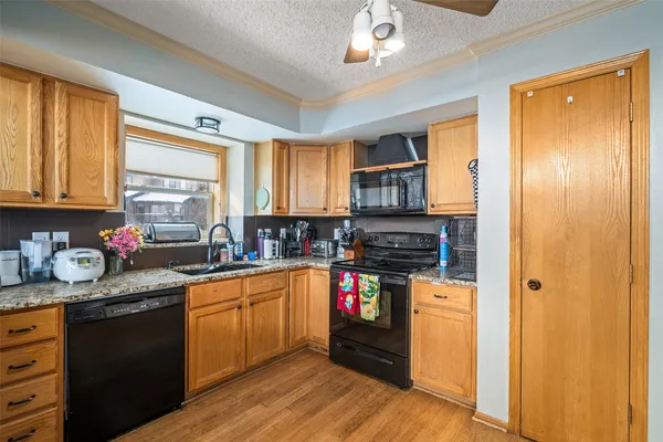 a kitchen with stainless steel appliances granite countertop a stove sink and cabinets