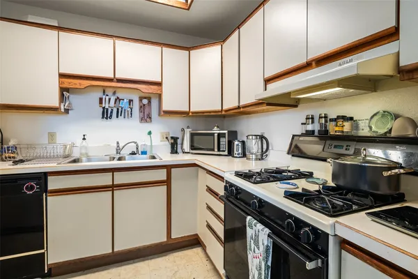 a kitchen with stainless steel appliances granite countertop a stove and a sink