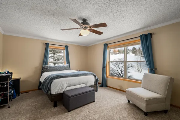a spacious bedroom with a bed and a large window