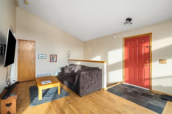 a spacious bedroom with a bed and a flat screen tv