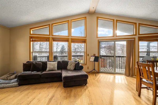 a living room with furniture and a floor to ceiling window
