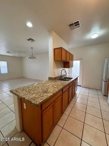 a kitchen with stainless steel appliances granite countertop a sink stove and cabinets