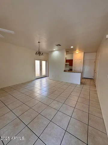 a view of a hallway and a chandelier fan