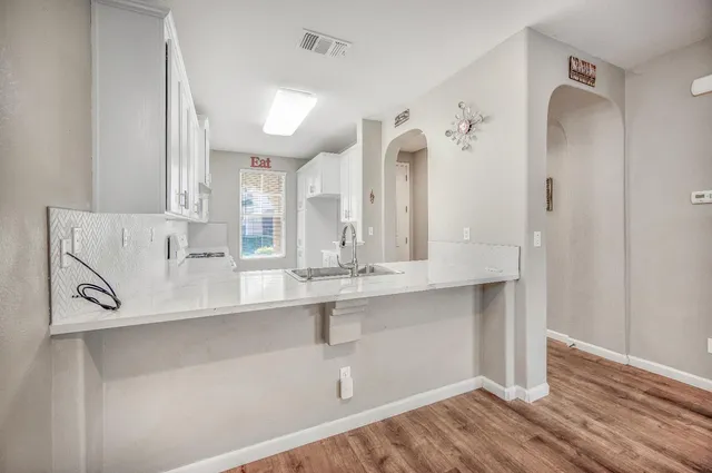 a view of cabinets and wooden floor