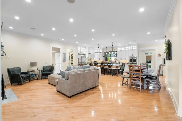 a living room with furniture kitchen view and a dining table