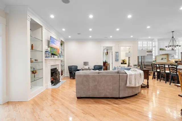 a living room with furniture a fireplace and a kitchen view