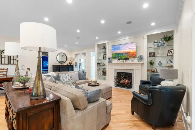 a living room with furniture a fireplace and a flat screen tv