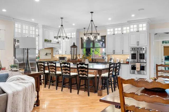 a large kitchen with a table and chairs