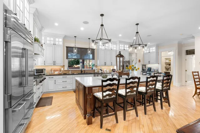 a large kitchen with a table and chairs