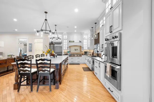 a kitchen with stainless steel appliances kitchen island granite countertop a large island in the center