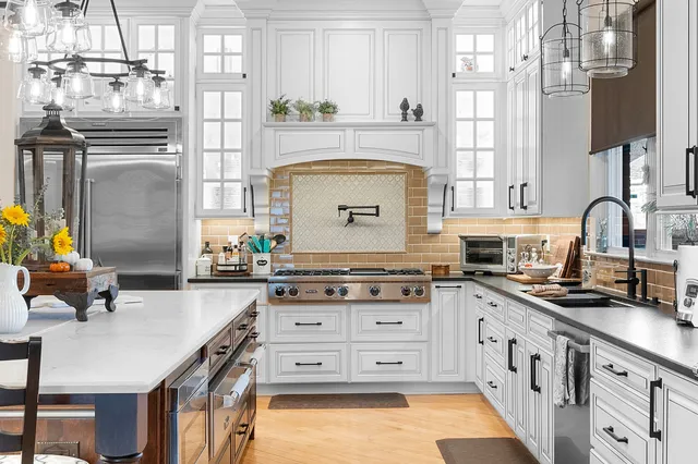 a kitchen with stainless steel appliances a sink stove and cabinets