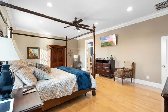 a spacious bedroom with a bed a couch and dresser