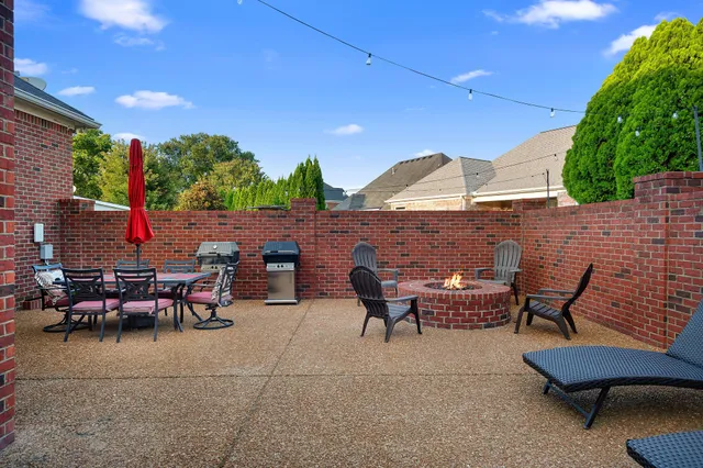 a view of an outdoor sitting area with brick walls