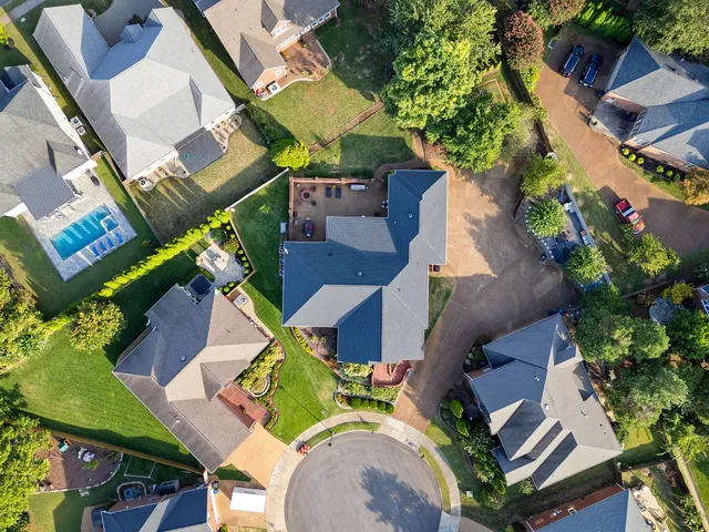 an aerial view of a house with garden space and street view