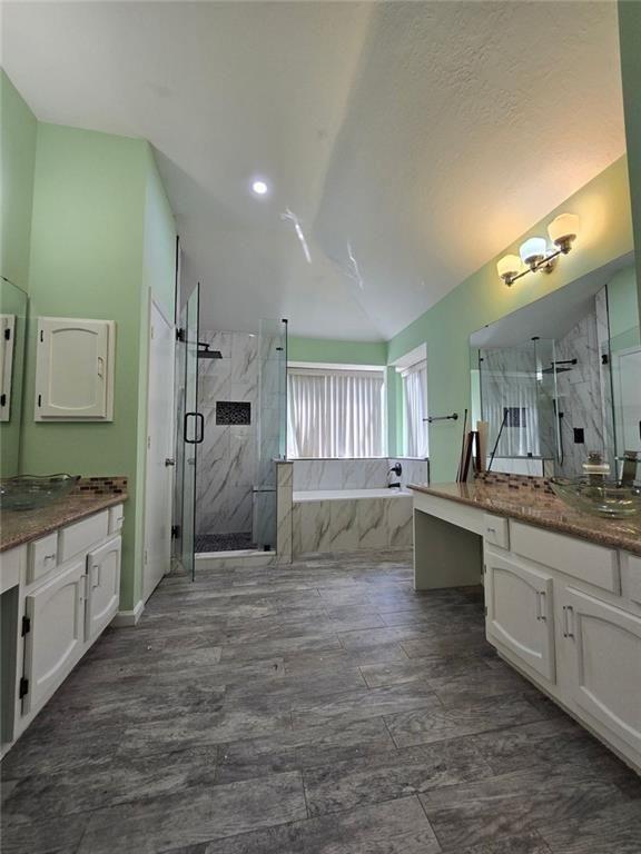 6992 Ivy Pointe Row Austell, GA 30168 - Photo 20 of 30 a large bathroom with a granite countertop double vanity sink a mirror and a bathtub
