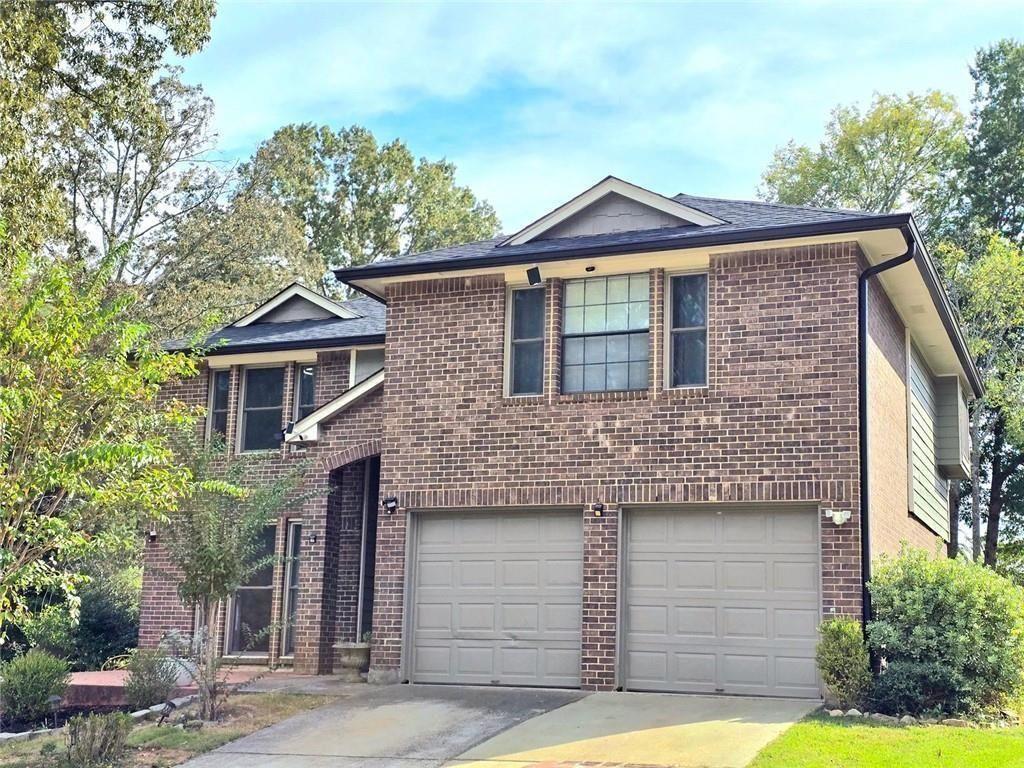 6992 Ivy Pointe Row Austell, GA 30168 - Photo 2 of 30 a front view of a house with a garden