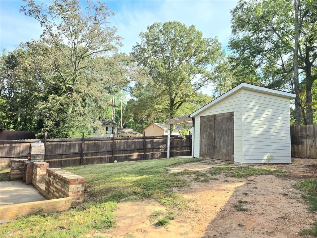 6992 Ivy Pointe Row Austell, GA 30168 - Photo 29 of 30 a view of a house with a small yard and a large tree