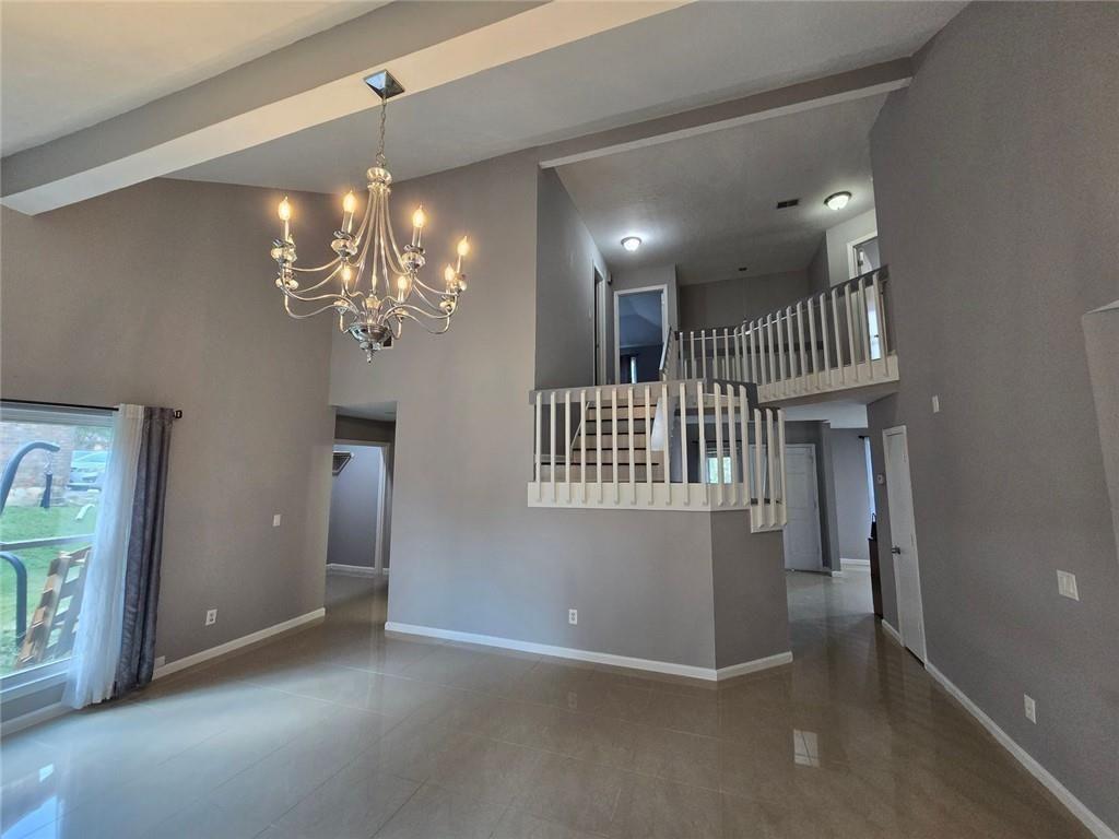 6992 Ivy Pointe Row Austell, GA 30168 - Photo 6 of 30 wooden floor in a hall with a chandelier and a mirror