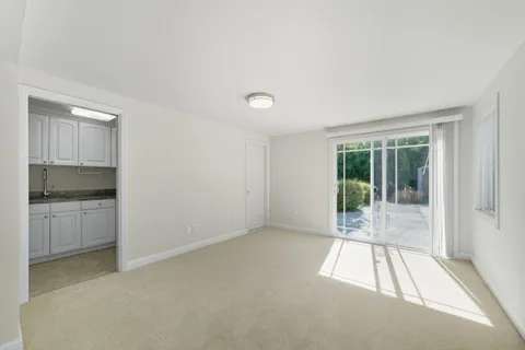 a view of an empty room with a kitchen