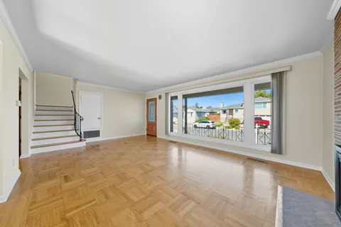 an empty room with furniture and a window