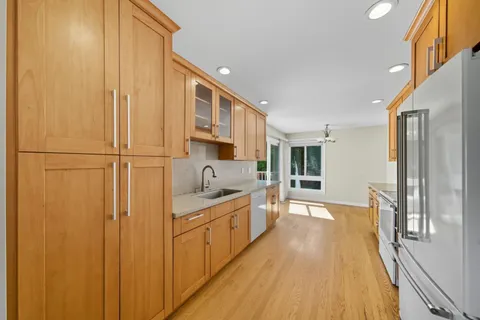 a view of a kitchen with a sink and wooden floor