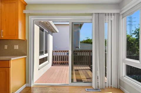 a view of a hallway with wooden floor and entryway