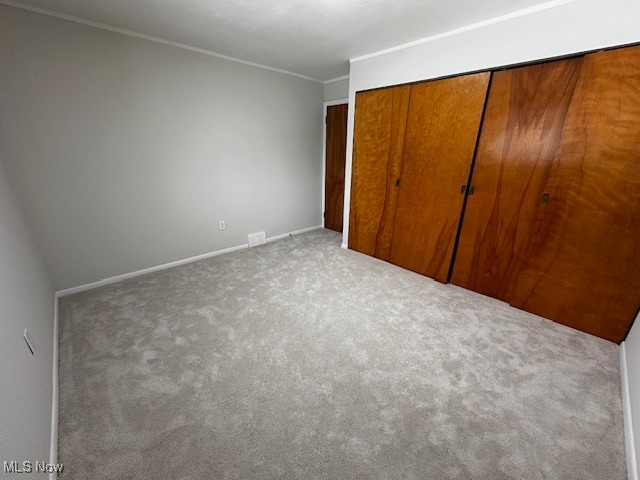 6606 Crossview Road Independence, OH 44131 - Photo 14 of 17 Unfurnished bedroom featuring ornamental molding, a closet, and carpet floors