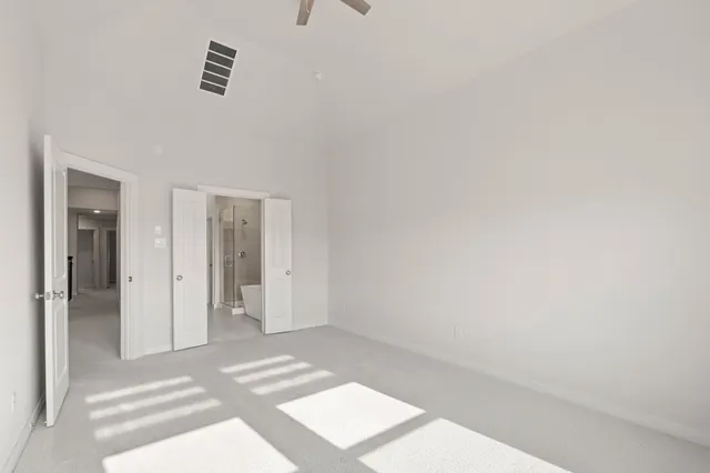 a bathroom with a tub sink shower and two mirror