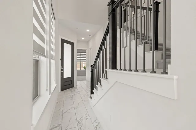 a view of staircase with white walls and a window