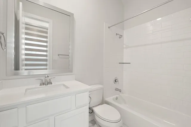a bathroom with a sink toilet a vanity and bathtub