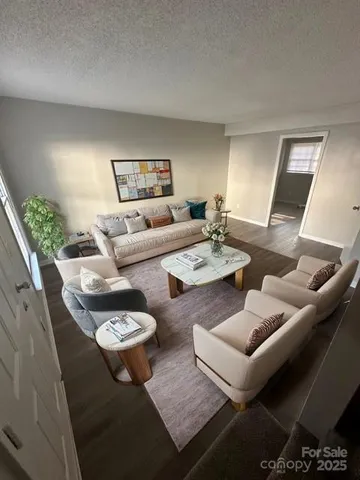 a living room with furniture and wooden floor