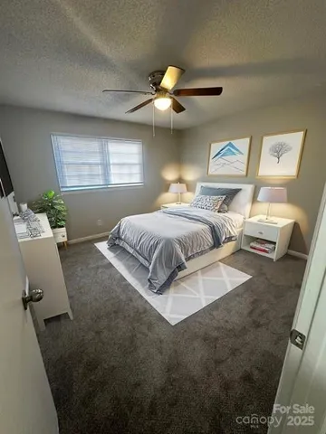 a spacious bedroom with a bed and a chandelier