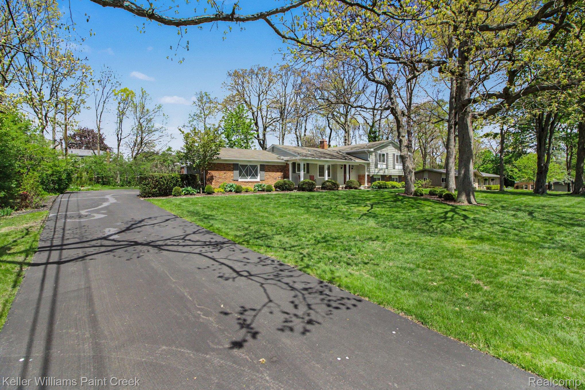 3370 Aquinas Drive Rochester, MI 48309 - Photo 18 of 25 Split level home featuring a chimney, a front lawn, brick siding, and driveway