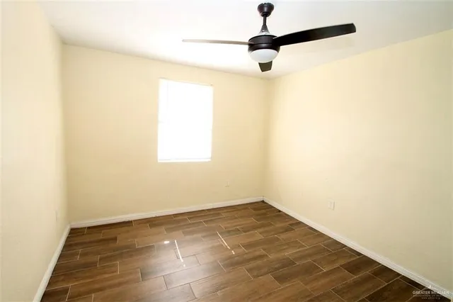 a view of a room with wooden floor and a window