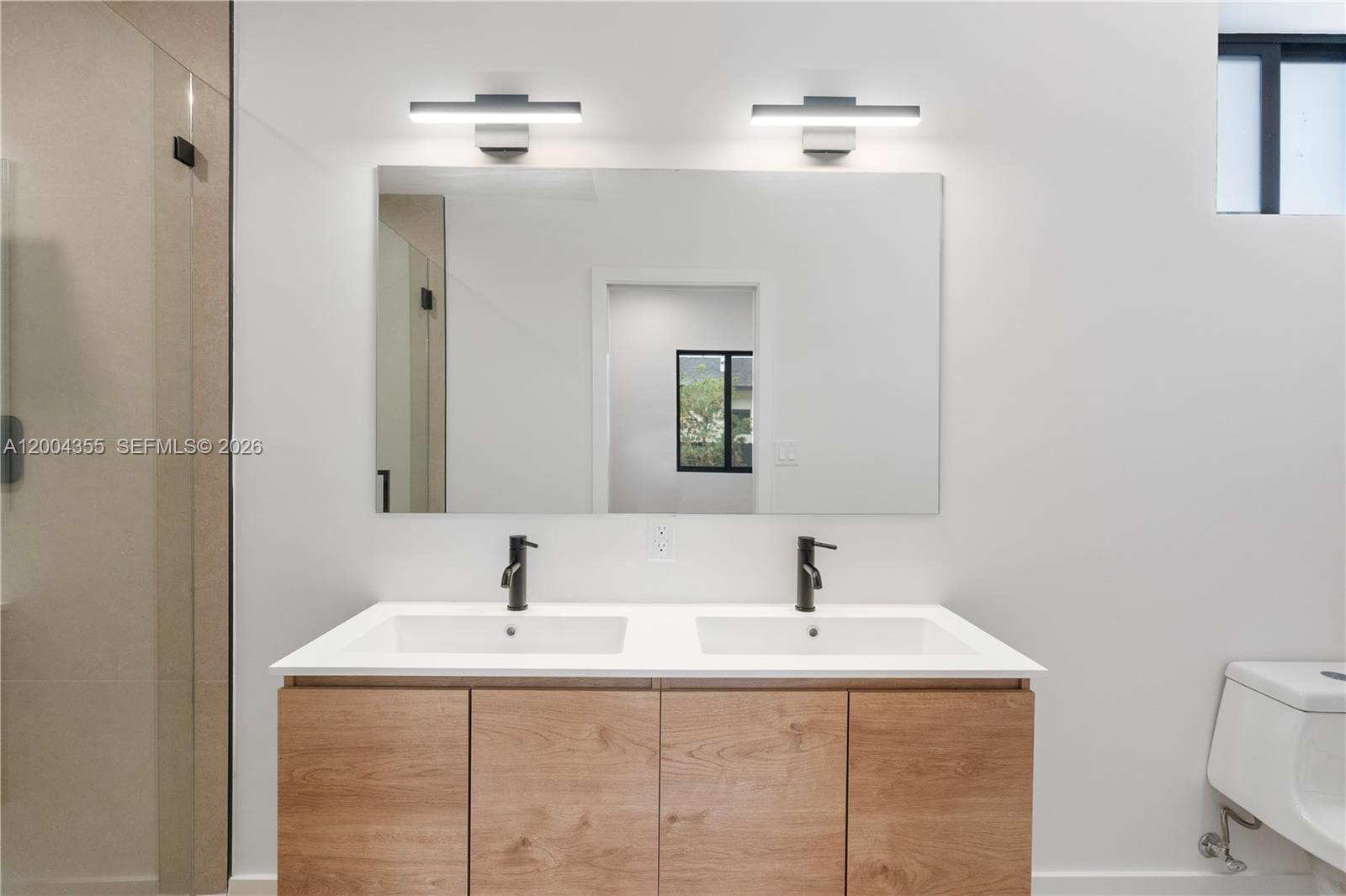 4518 Northwest 4th Street Miami, FL 33126 - Photo 11 of 23 a bathroom with a sink and a mirror