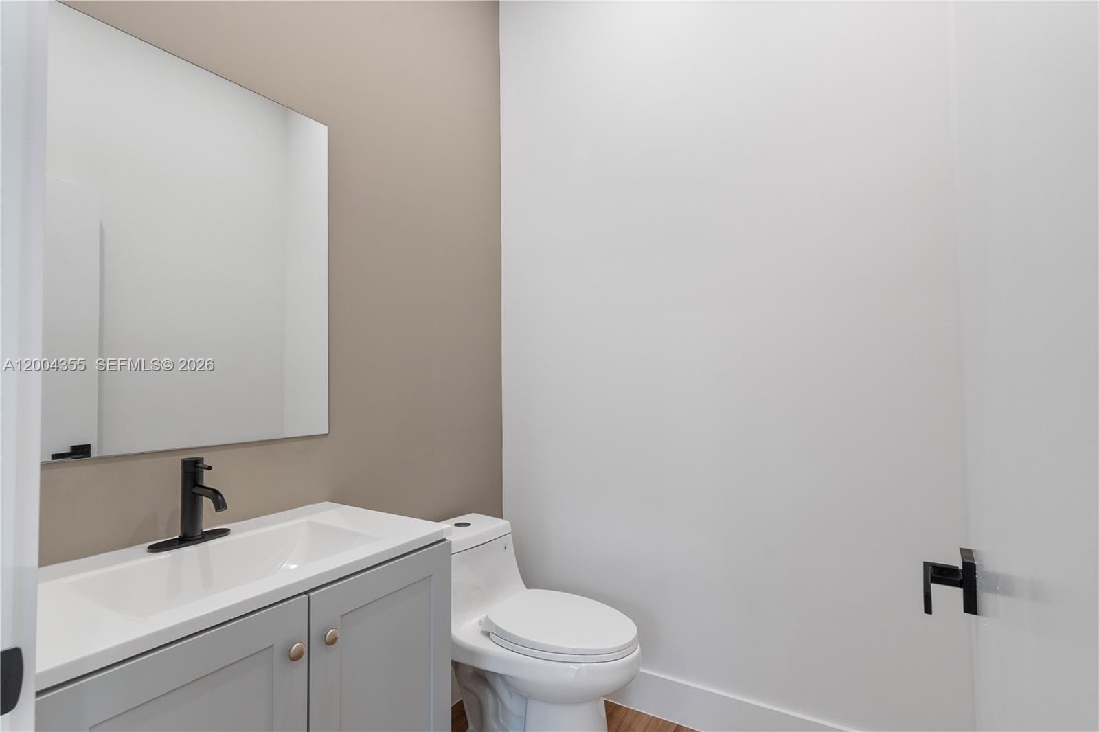 4518 Northwest 4th Street Miami, FL 33126 - Photo 12 of 23 a bathroom with a granite countertop toilet and sink