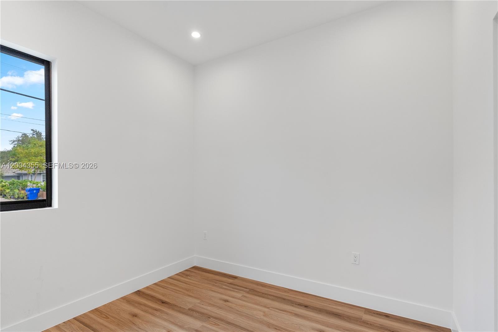 4518 Northwest 4th Street Miami, FL 33126 - Photo 13 of 23 a view of a small space with wooden floor and a window