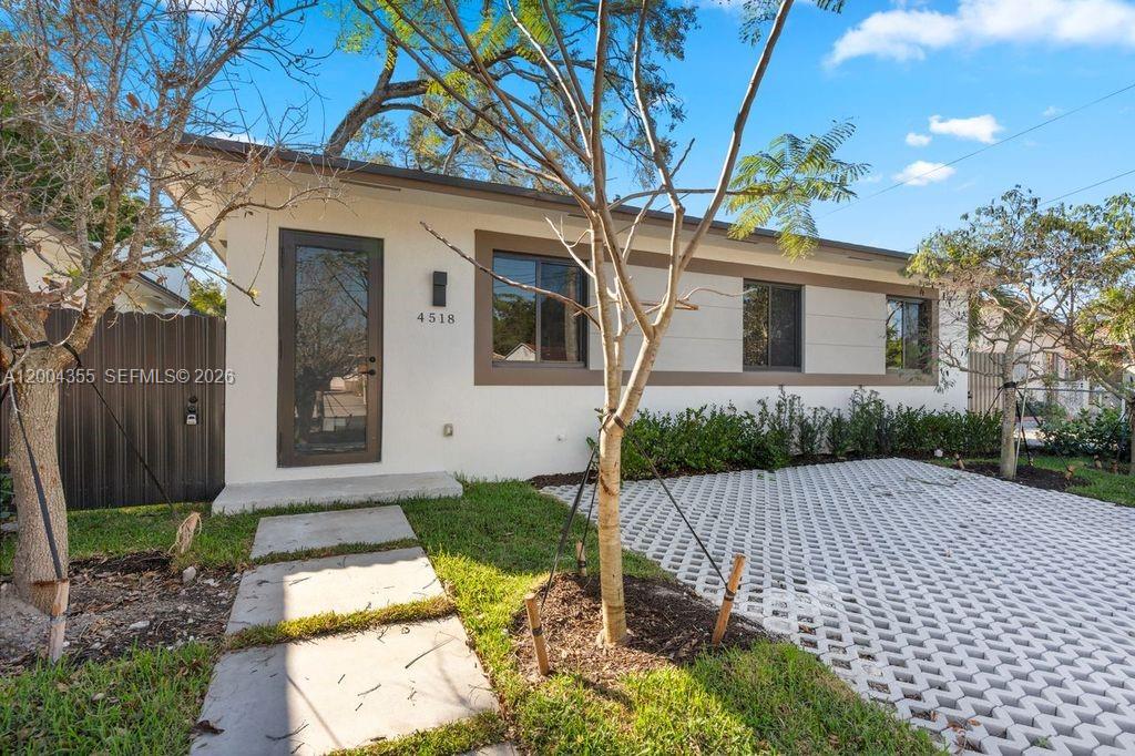 4518 Northwest 4th Street Miami, FL 33126 - Photo 20 of 23 a front view of a house with a yard