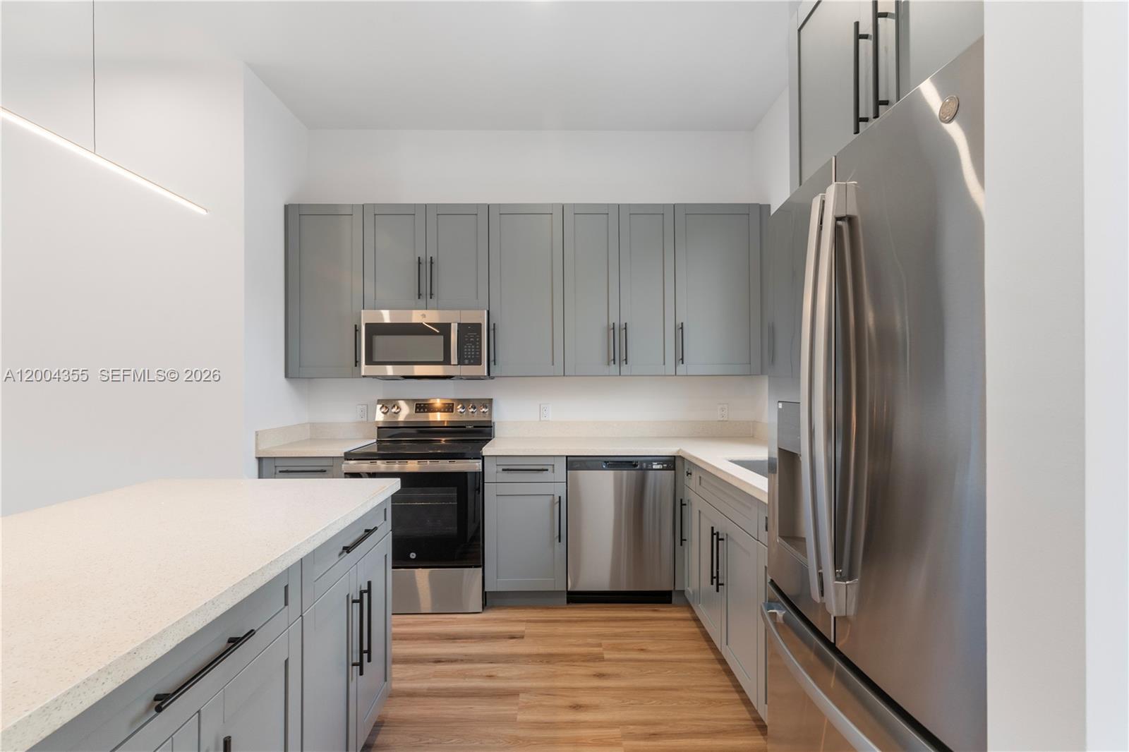 4518 Northwest 4th Street Miami, FL 33126 - Photo 4 of 23 a kitchen with a sink and stainless steel appliances