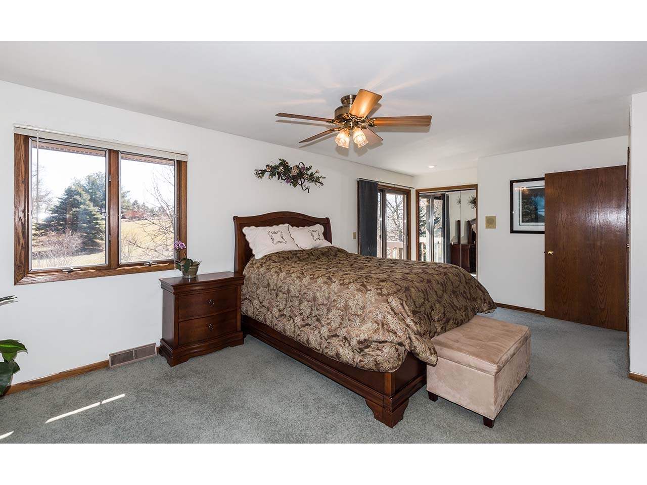 4571 East Marrill Road Byron, IL 61010 - Photo 12 of 25 a bedroom with a bed and a chandelier