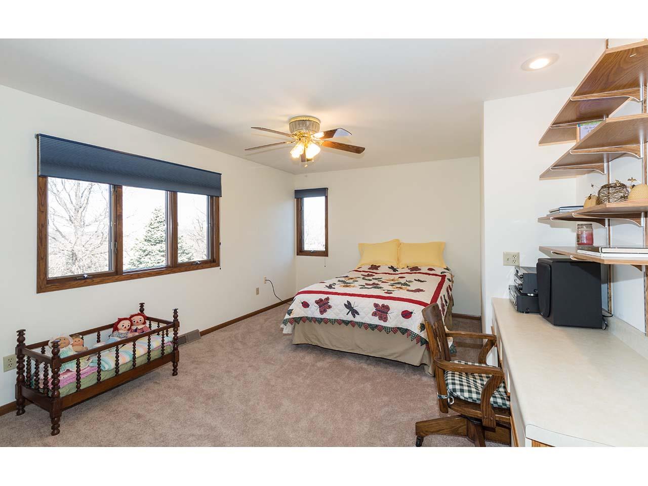 4571 East Marrill Road Byron, IL 61010 - Photo 13 of 25 a bedroom with a bed and a chandelier