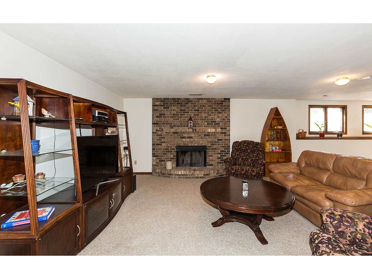 4571 East Marrill Road Byron, IL 61010 - Photo 18 of 25 a living room with furniture a flat screen tv and a fireplace