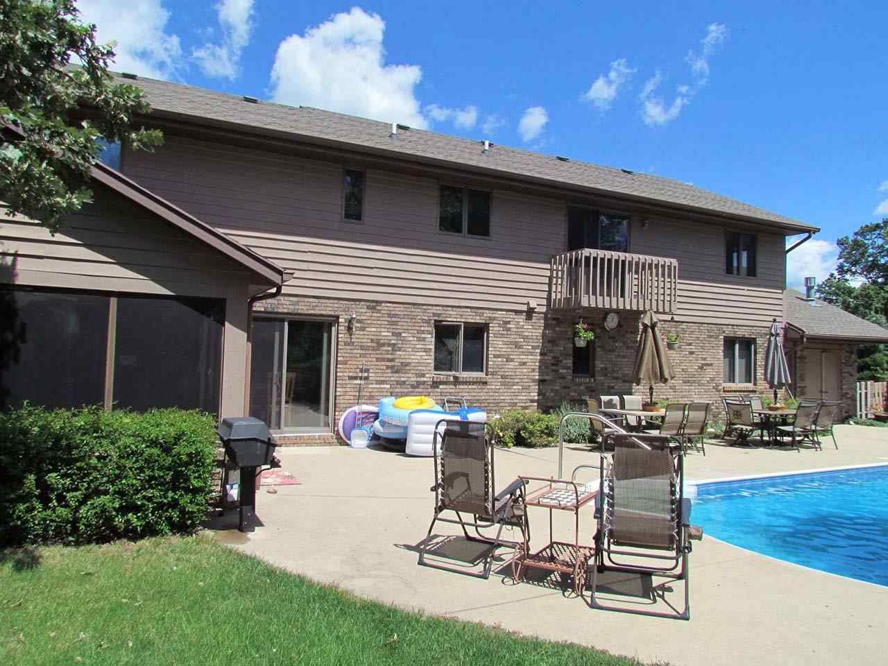 4571 East Marrill Road Byron, IL 61010 - Photo 21 of 25 a view of a patio with table and chairs with plants and wooden fence