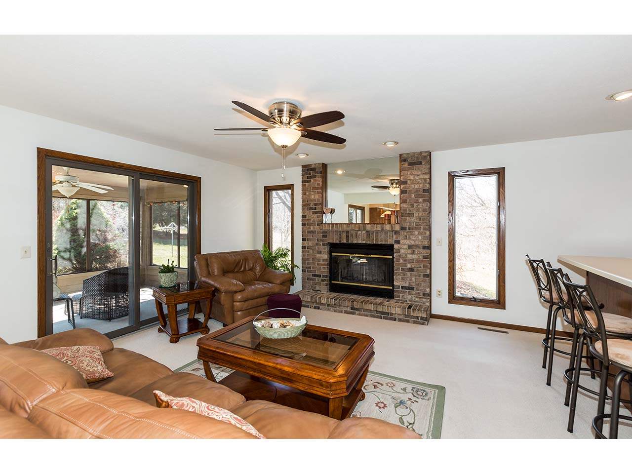 4571 East Marrill Road Byron, IL 61010 - Photo 3 of 25 a living room with furniture a fireplace and a large window