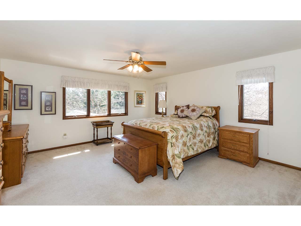 4571 East Marrill Road Byron, IL 61010 - Photo 10 of 25 a spacious bedroom with a bed and a chandelier
