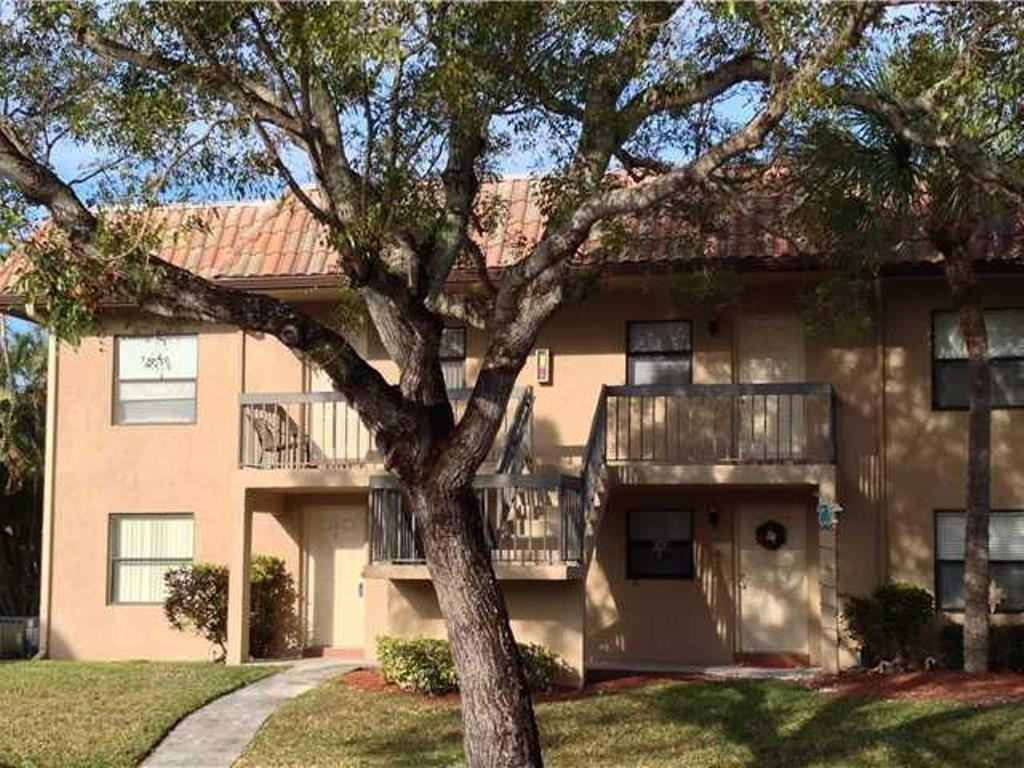6796 Palmetto Circle South, Unit 101 Boca Raton, FL 33433 - Photo 1 of 29 a front view of a house with garage